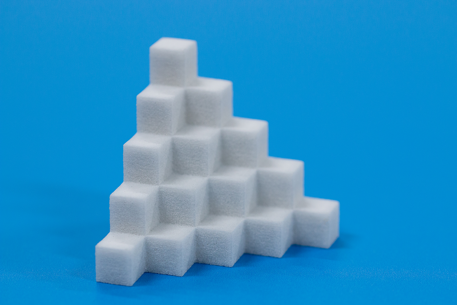 a white cubes stacked in a pyramid