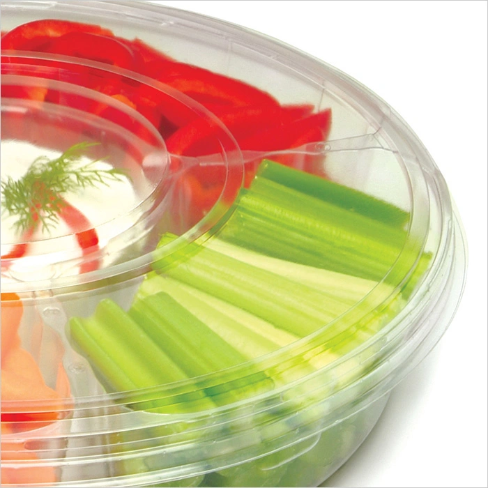 a plastic container with vegetables in it