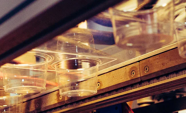 plastic cups on a conveyor belt