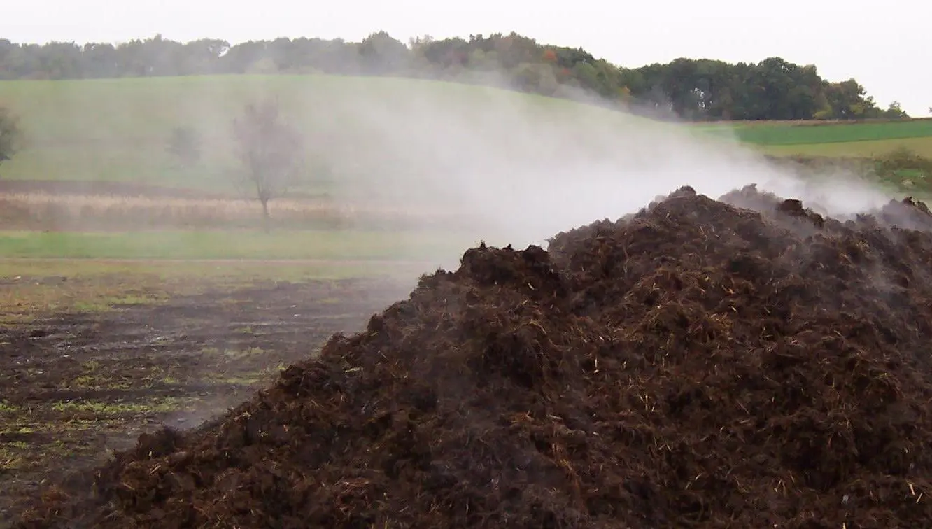 a pile of dirt with steam coming out of it