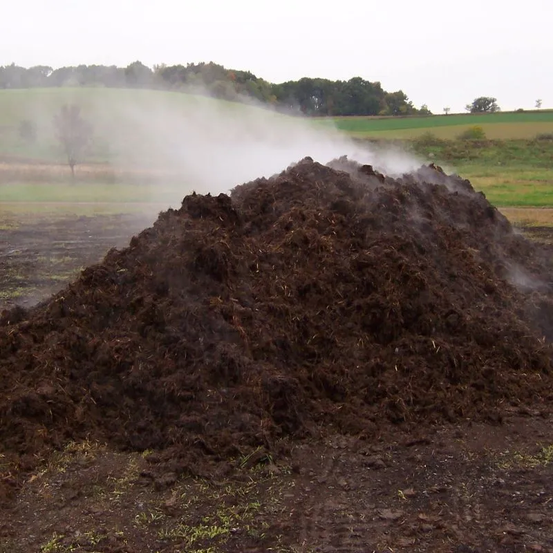 a pile of dirt with steam coming out of it
