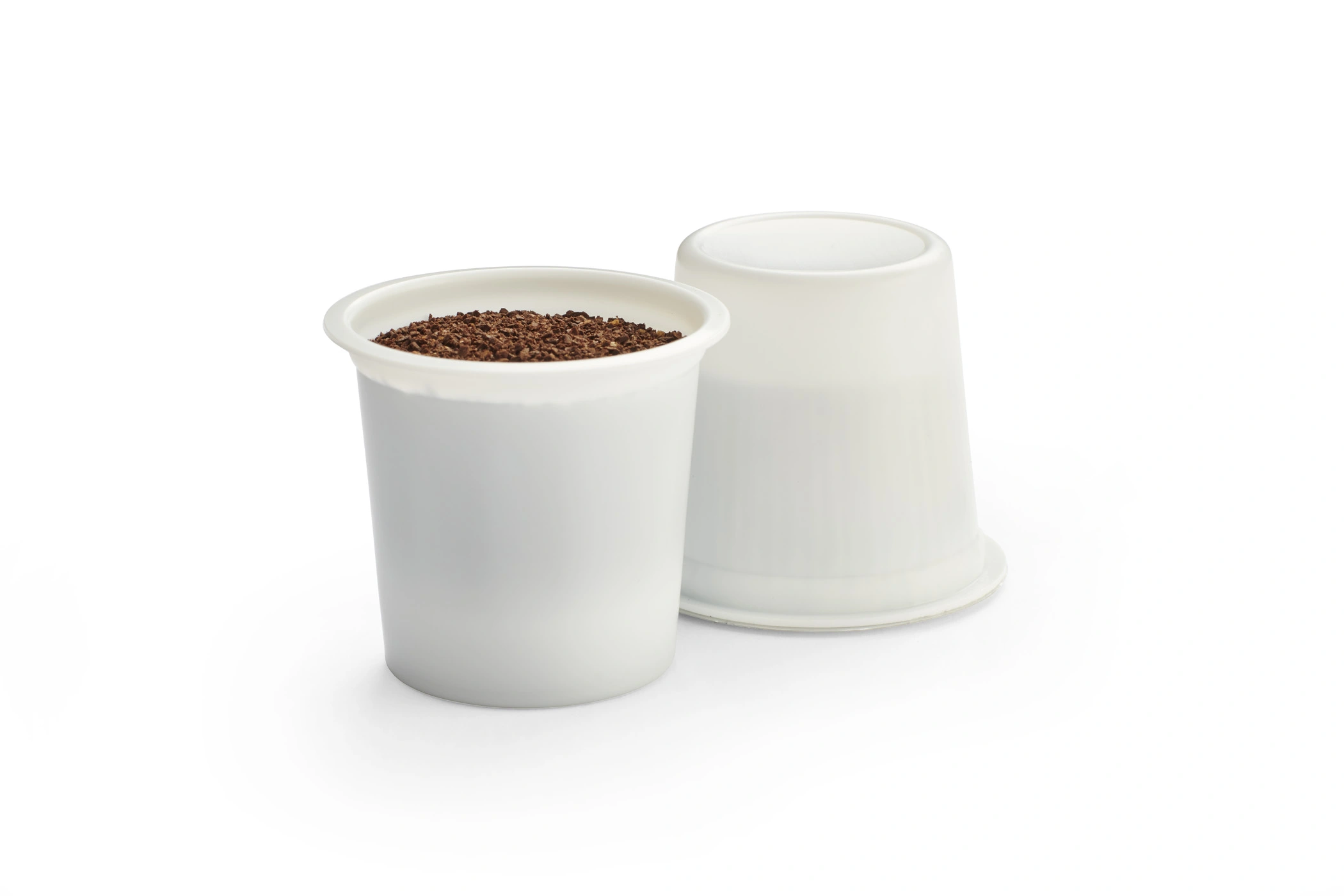 a white plastic cups with brown dirt inside