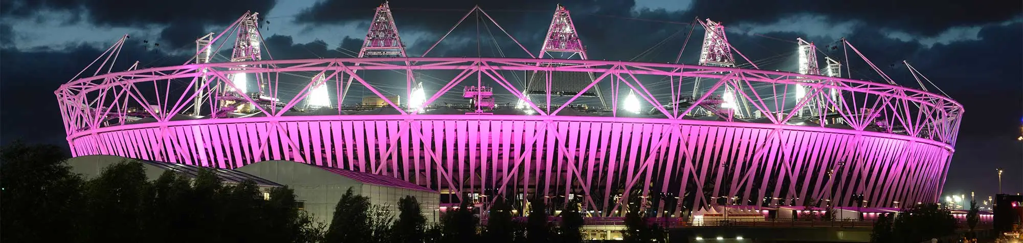 a pink metal structure with a triangle shaped roof